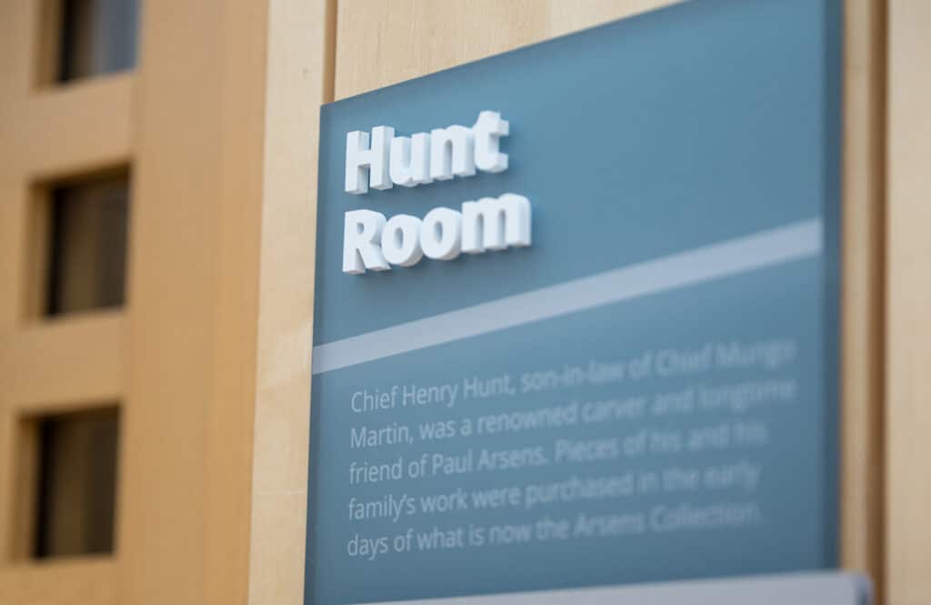 Hunt Room sign with illuminated 3D lettering on a blue background.