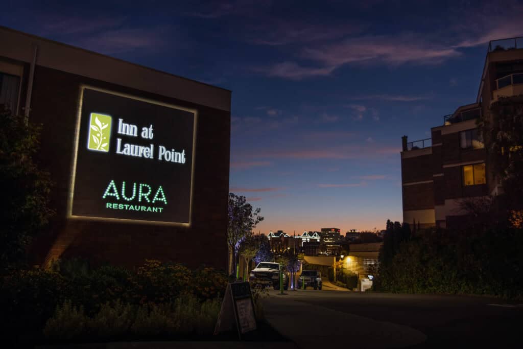 Inn at Laurel Point illuminated sign at dusk.