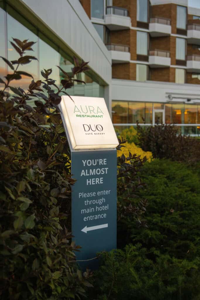 Hotel directional sign for Aura Restaurant and DUO Cafe.