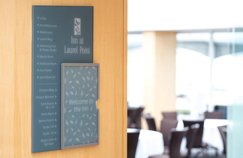 Inn at Laurel Point directional sign with room and facility listings.