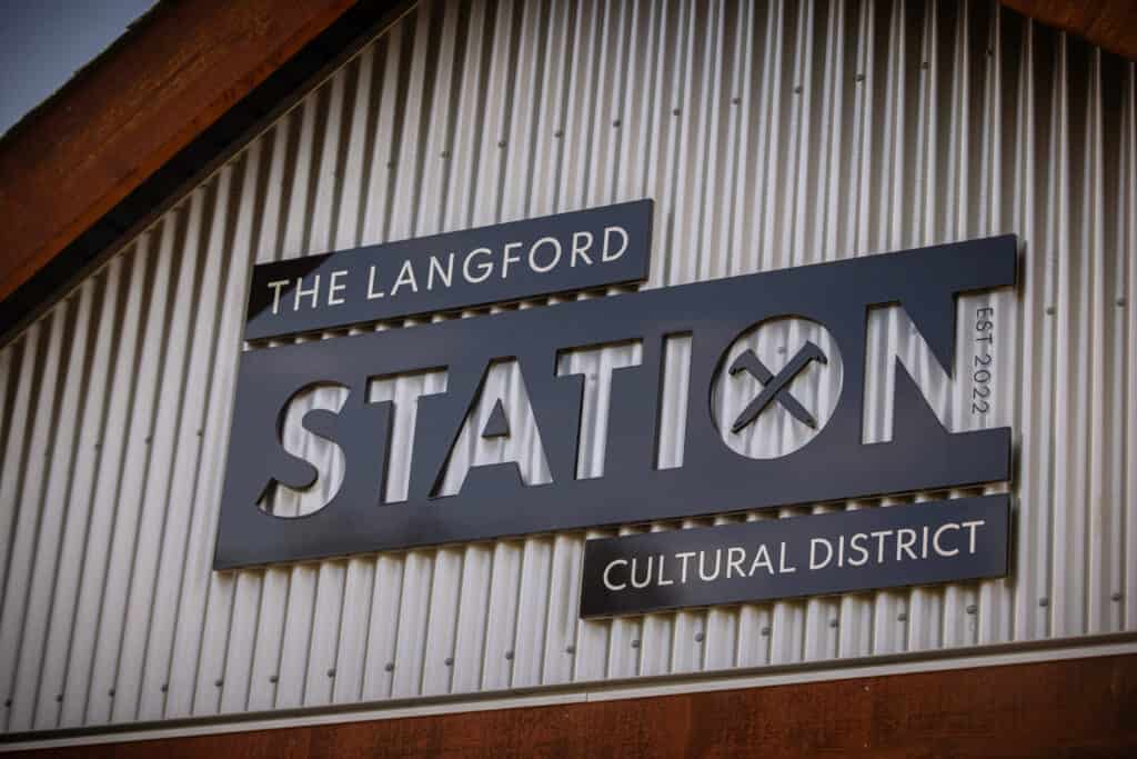 Custom metal sign for The Langford Station Cultural District in Victoria.