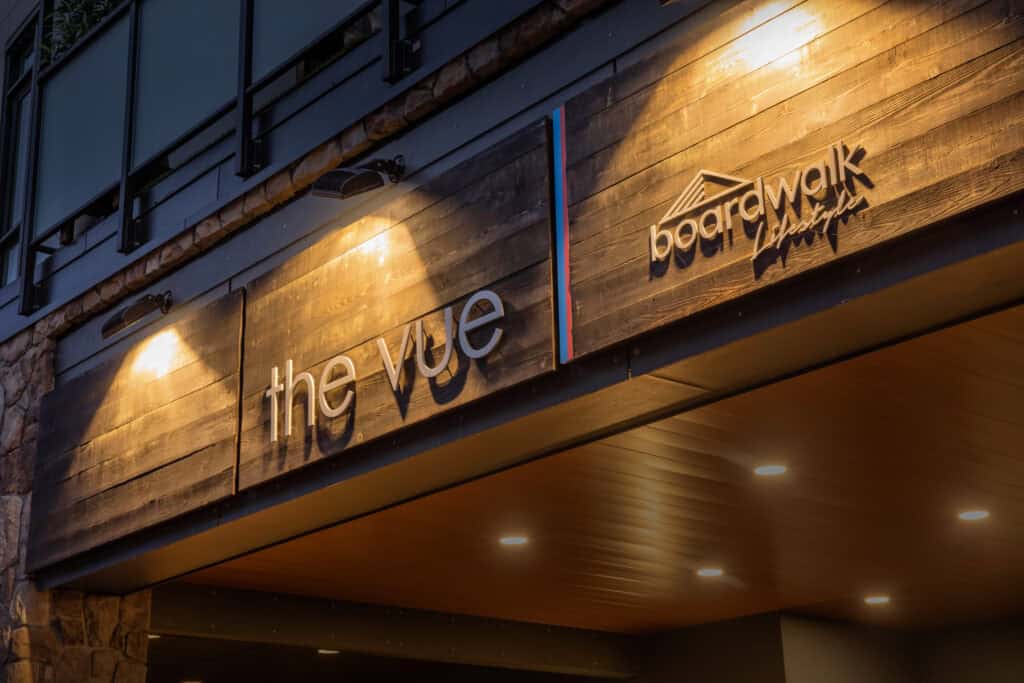 Custom business sign for The Vue and Boardwalk in Victoria, illuminated at night.