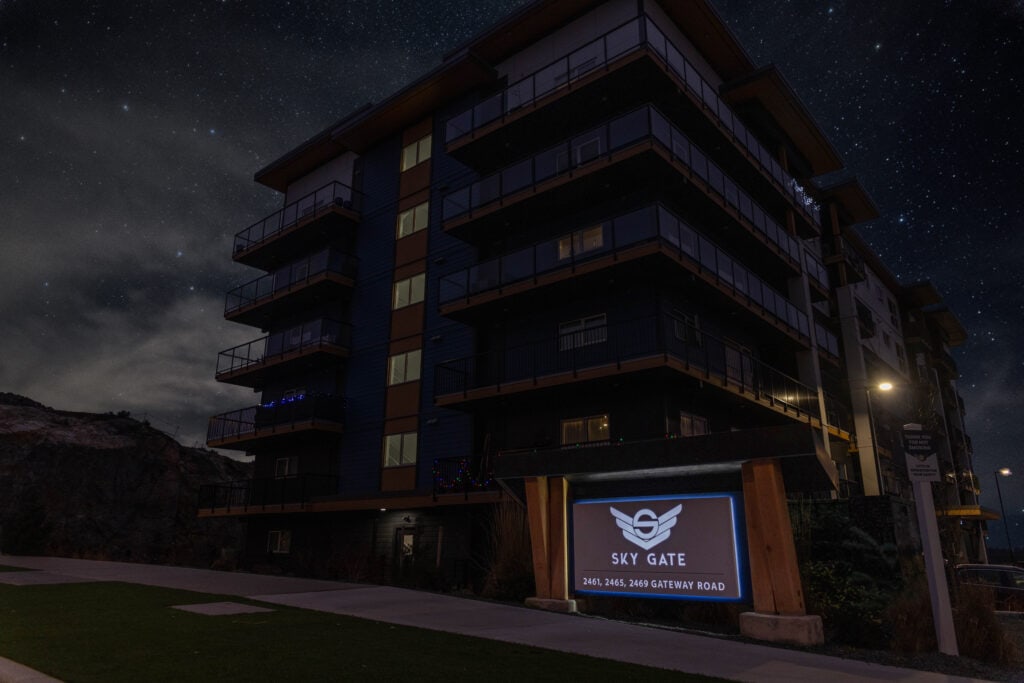 Night view of Sky Gate building with illuminated sign at Gateway Road.