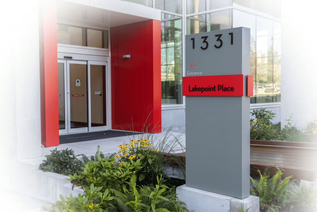 Modern outdoor wayfinding sign with address and directional arrow at Lakepoint Place.