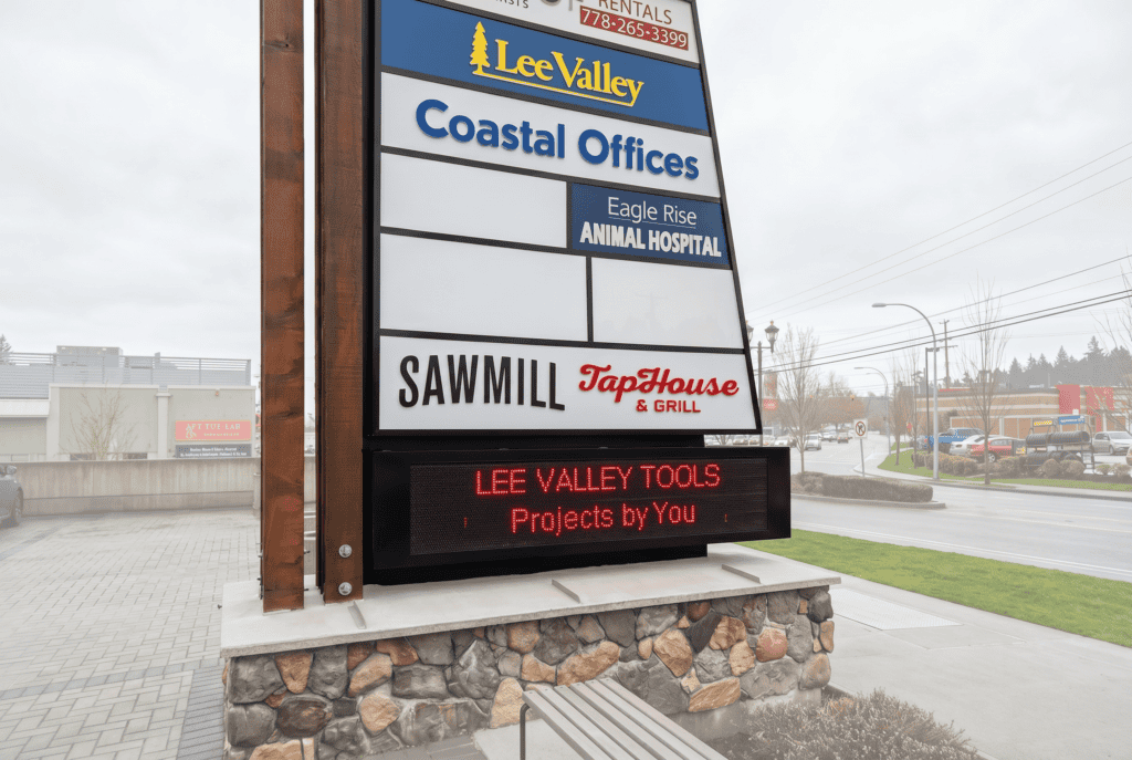 Digital message board displaying business advertisements in Victoria.