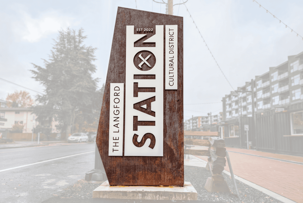A large rust-colored monument sign displaying "The Langford State" for the cultural district.