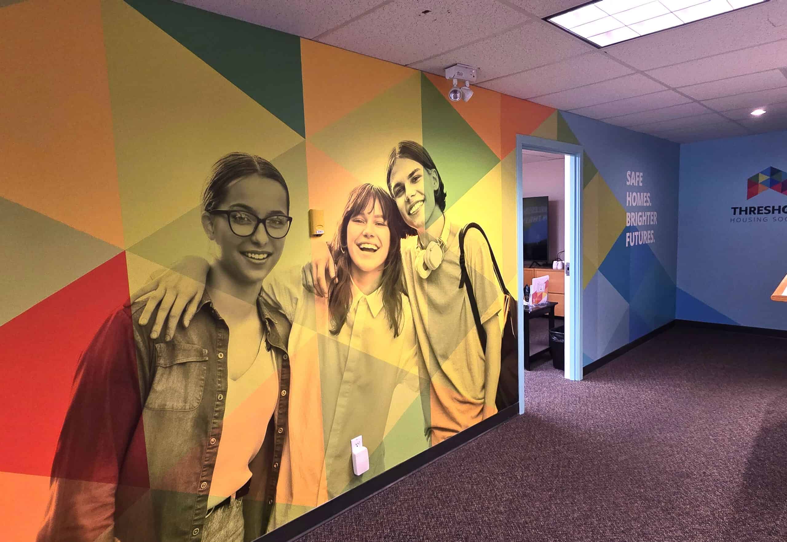 Vibrant wall graphics showcasing custom signs and vehicle wraps in Victoria.