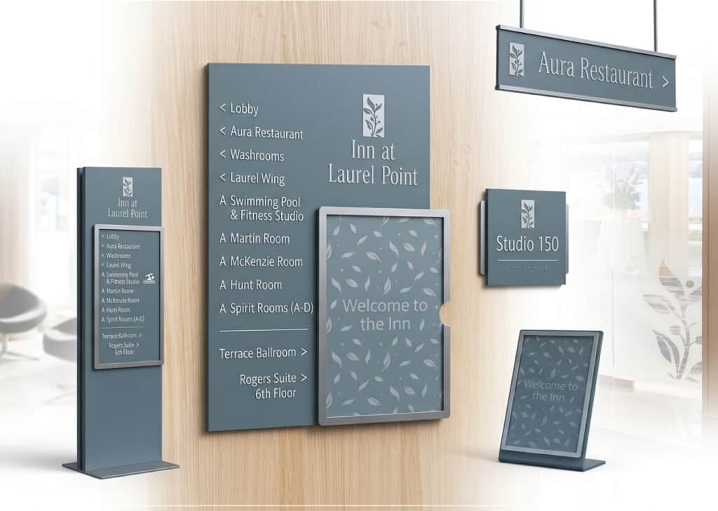 Modern indoor wayfinding signage with directional arrows and room labels at Laurel Point Inn.