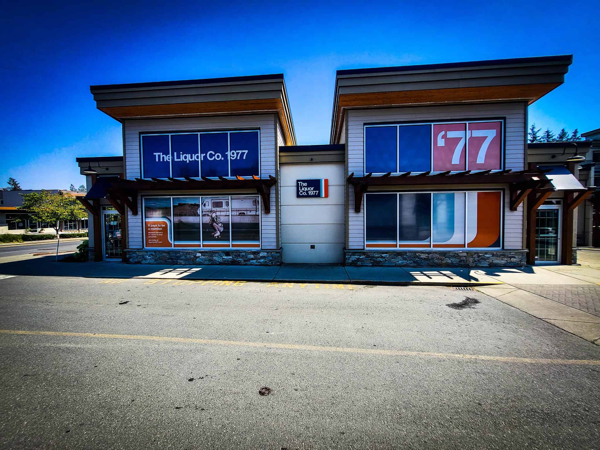 Commercial building with custom window and wall graphics for The Liquor Co. 1977 and '77.