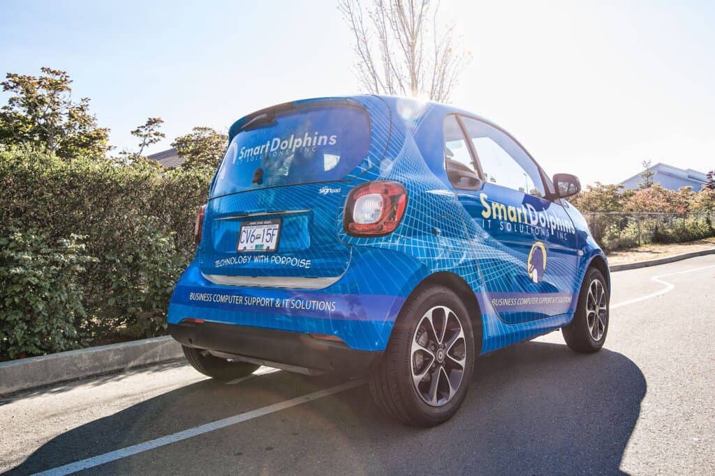 Custom vehicle wrap for Smart Dolphins with vibrant blue design.