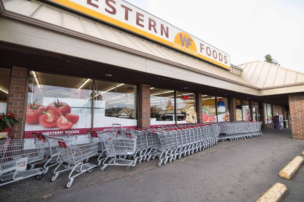 Sign Pad for Western Foods store in Victoria with custom signage and shopping carts outside.