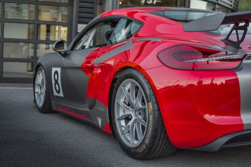 High-quality race car with a sleek red and black design, featuring a large rear wing and racing numb.