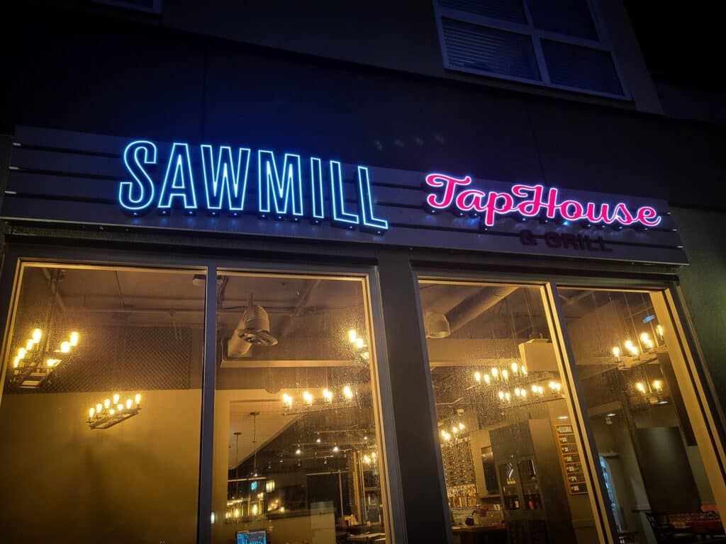 Modern neon sign for Sawmill TapHouse restaurant in Victoria.