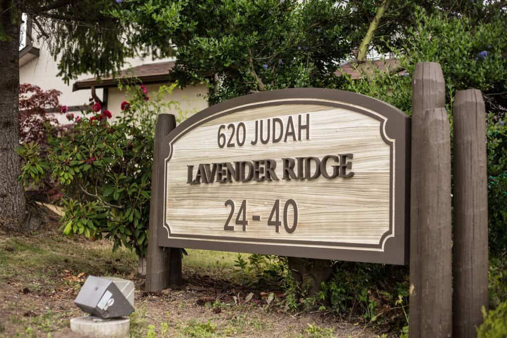 Custom outdoor house sign with engraved text for yard identification.