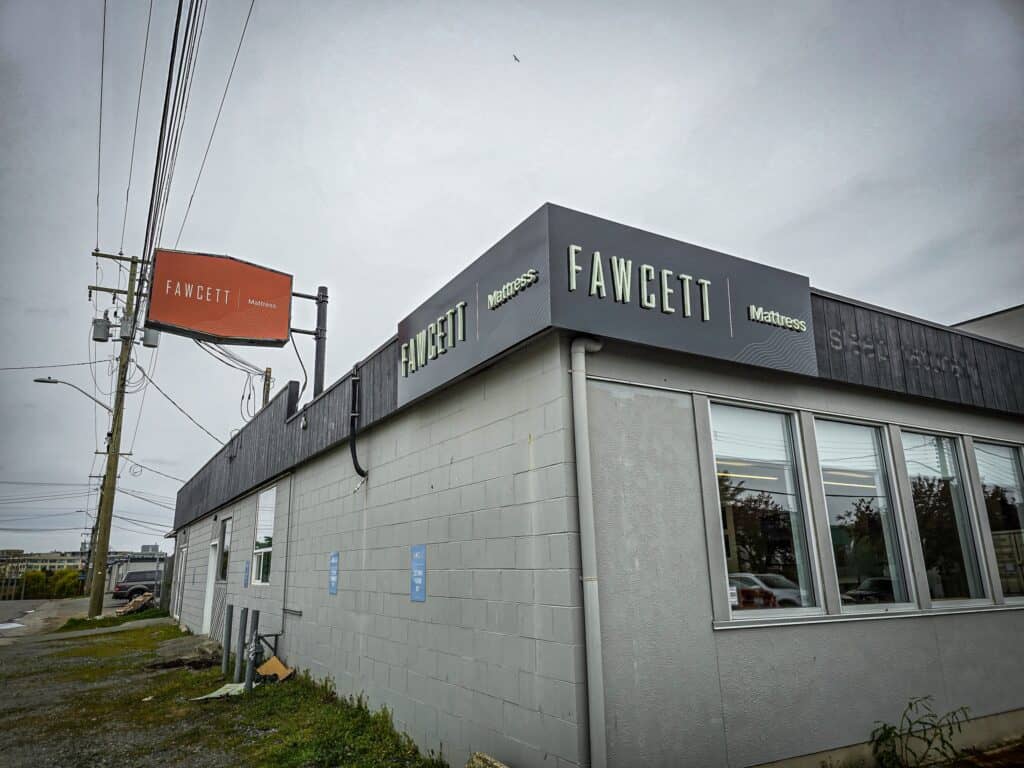 Exterior view of Fawcett signage on a commercial building in Victoria.