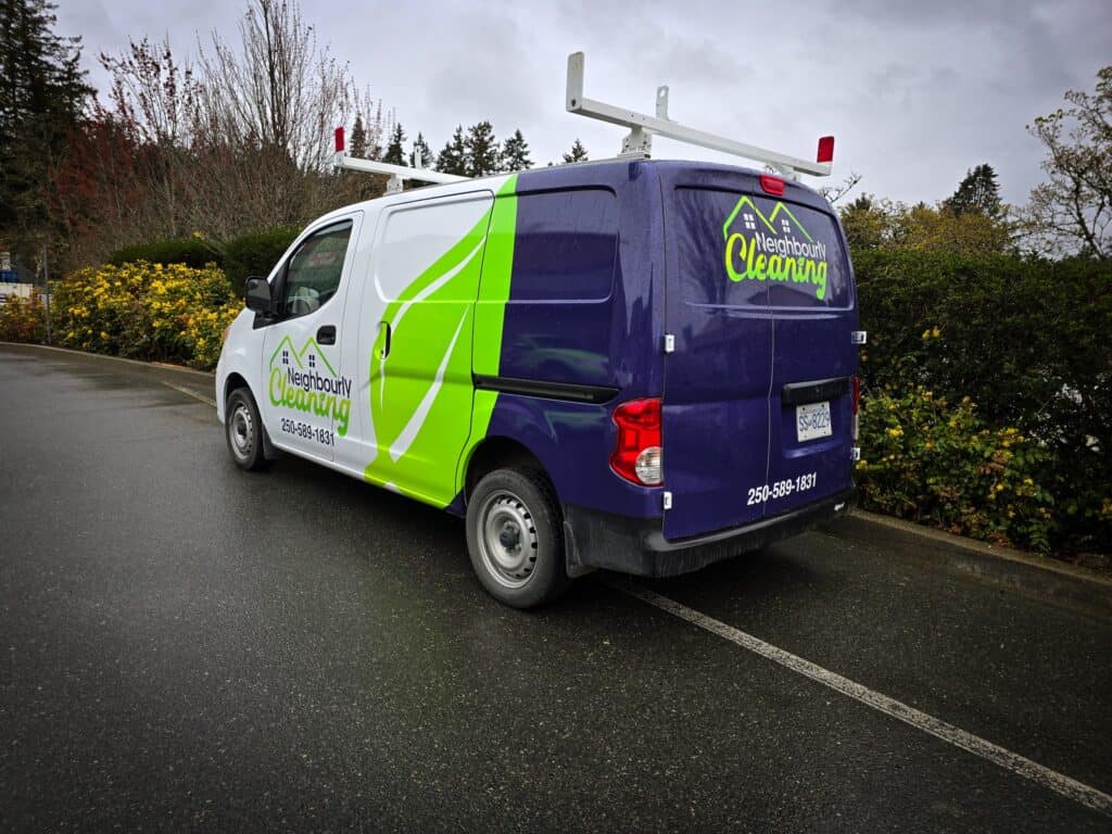 Custom neighbourhood cleaning van with vibrant green and blue graphics.