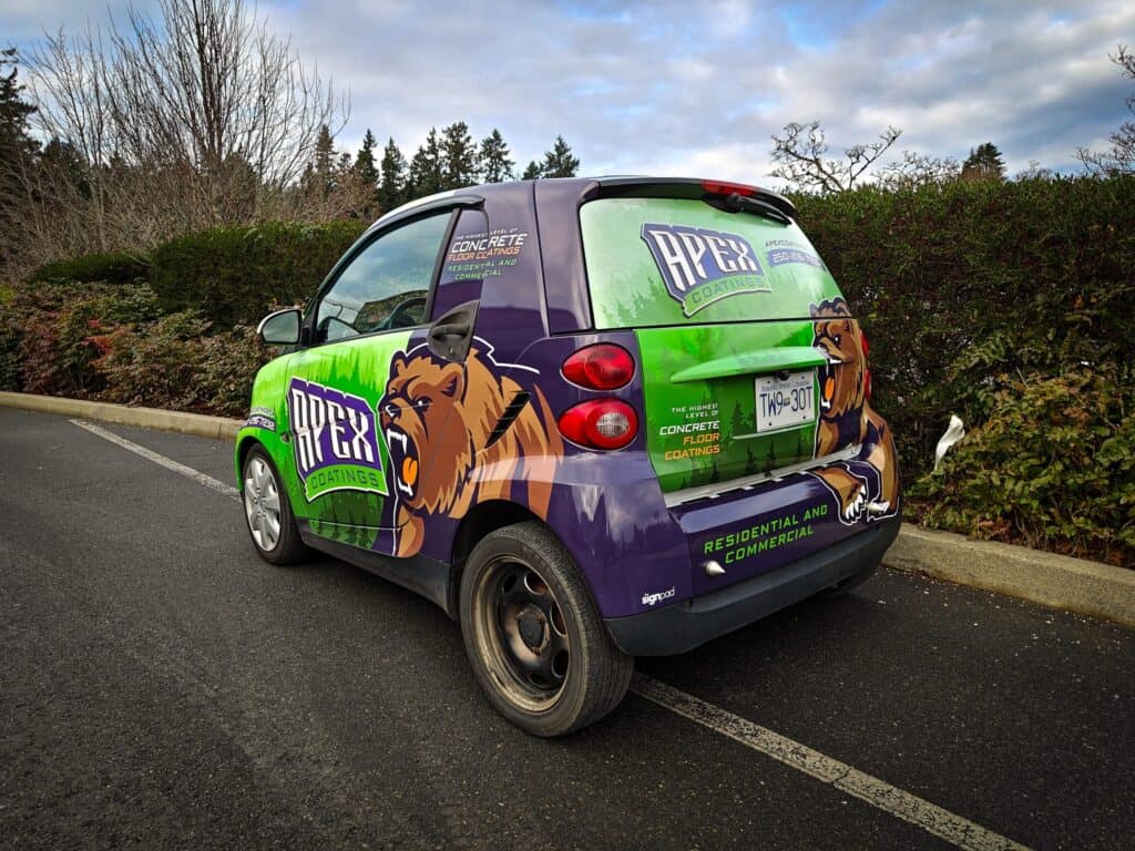 Vehicle wrap featuring the APEX Concrete logo and branding in green, purple, and brown for promotion.