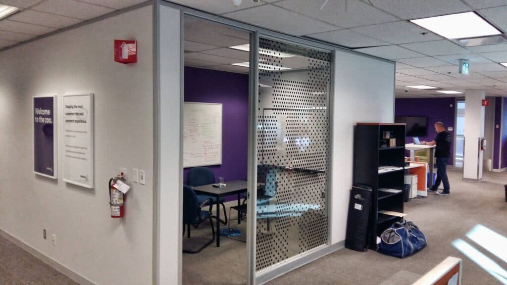 Office interior with signage, meeting space, and work area in Victoria.
