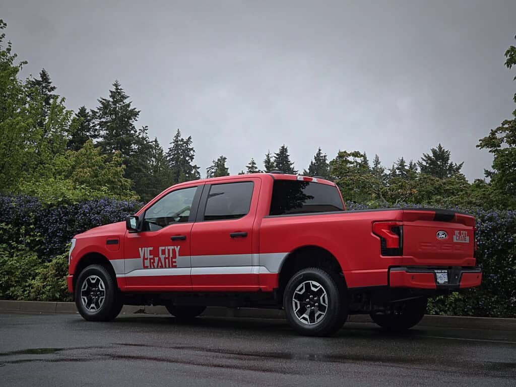 Vehicle wrap featuring a red pickup truck with custom signage.