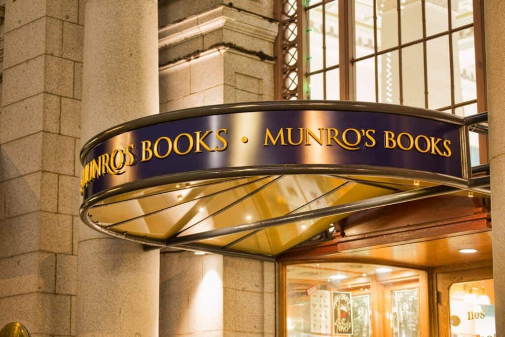 Munro's Books storefront sign in Victoria, featuring elegant gold lettering on a dark background.