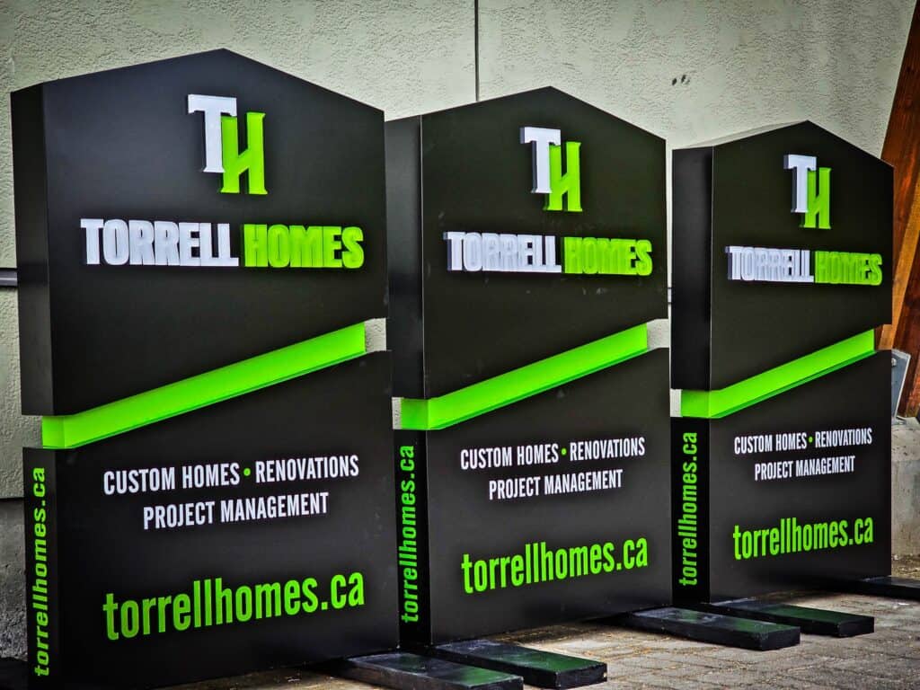 Custom Torrell Homes sign with green and black design for branding.