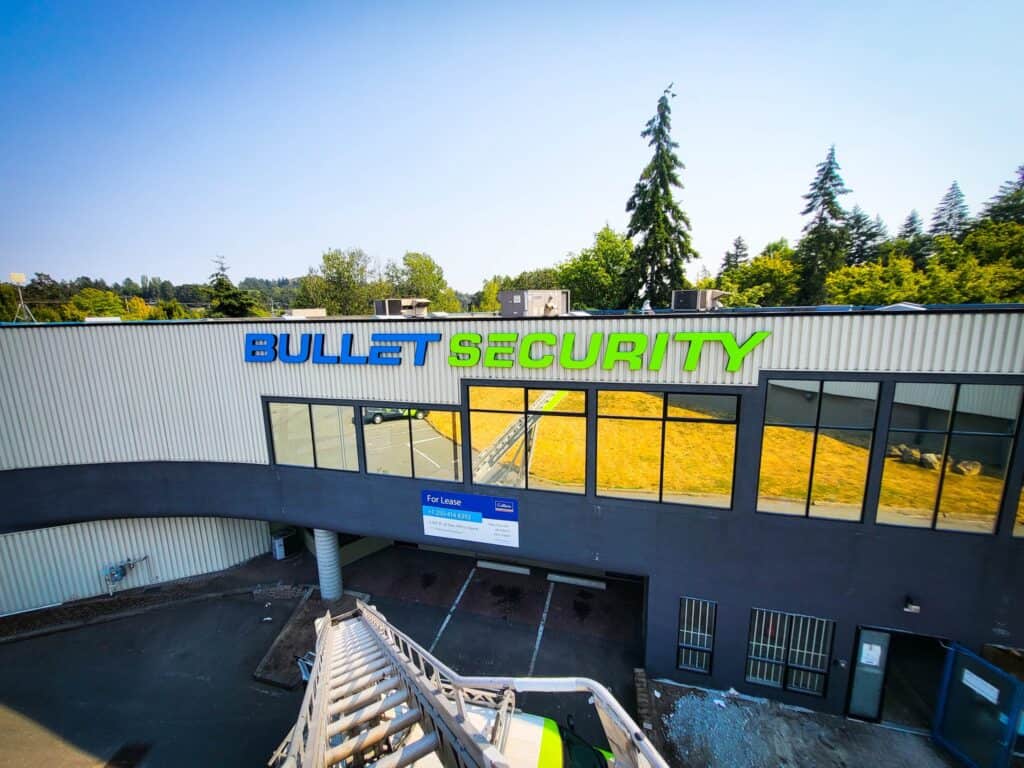 Bullet Security sign in blue and green on the exterior of a commercial building.