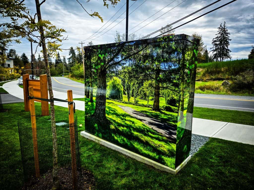 Custom sign with a vibrant forest scene for outdoor advertising or decoration.