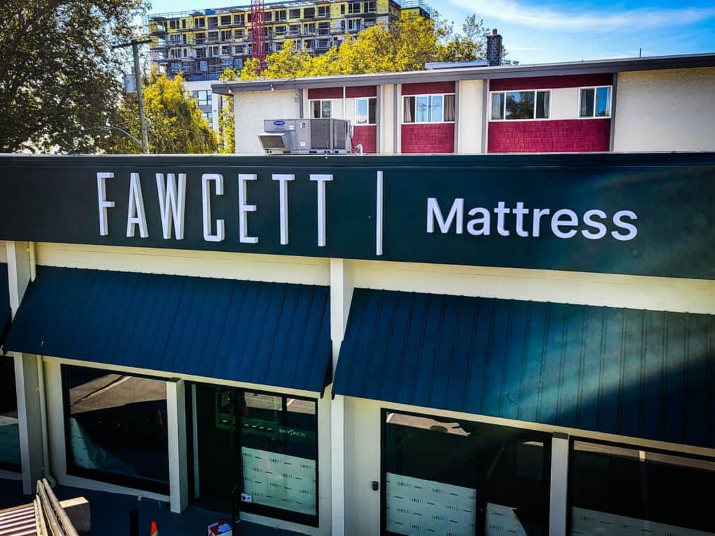 Exterior view of Fawcett Mattress store sign in Victoria.