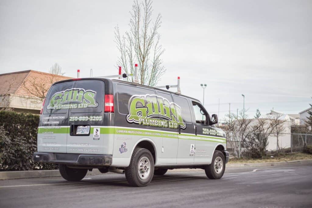 Plumbing service van with Gum's logo and contact info in Victoria.