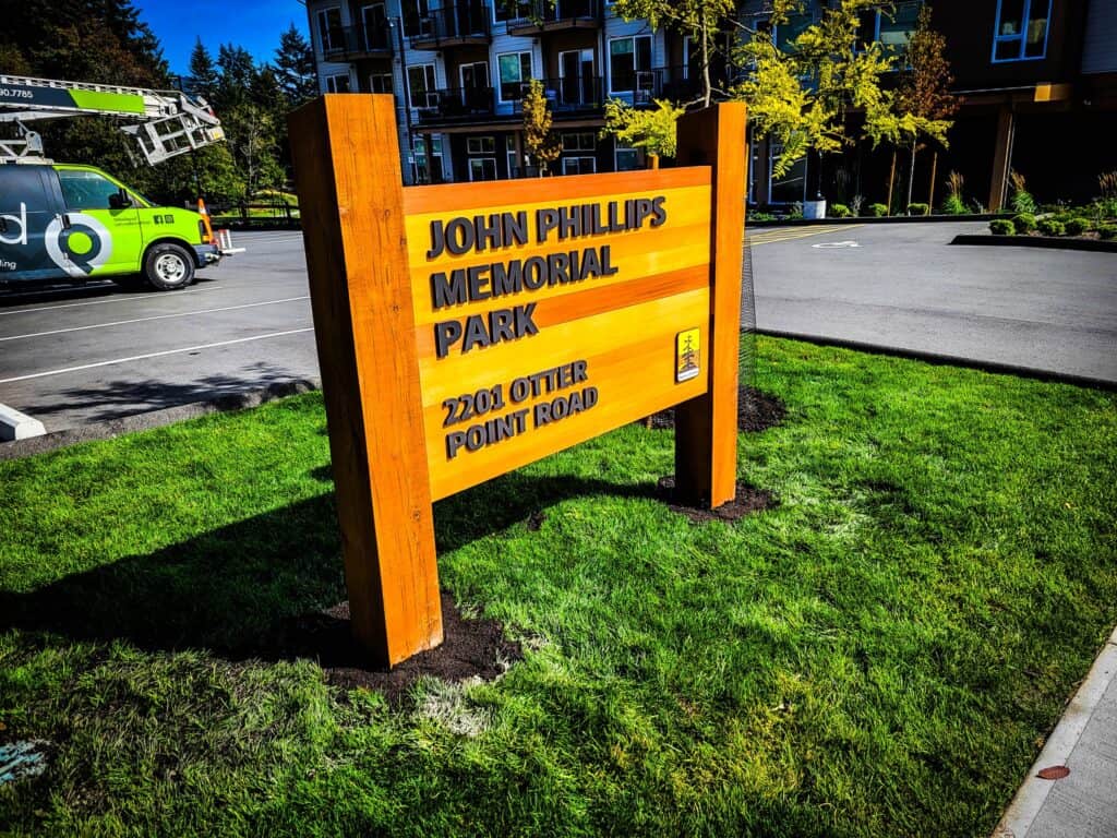 Sign for John Phillips Memorial Park with address details.