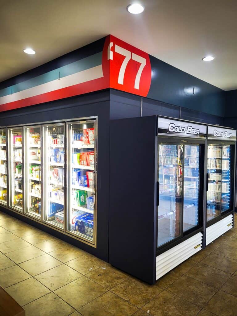 Commercial refrigeration units with glass doors for cold beverages and snacks.