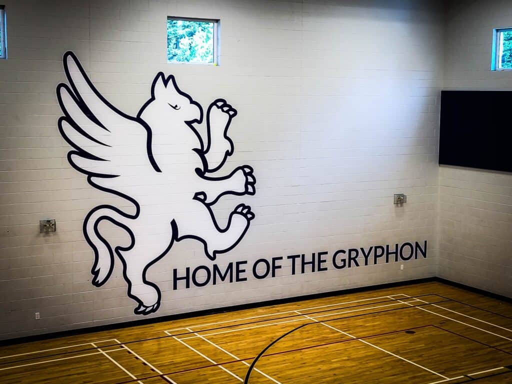 Gryphon mascot wall sign for Victoria sports venue, showcasing custom signage and vehicle wraps.