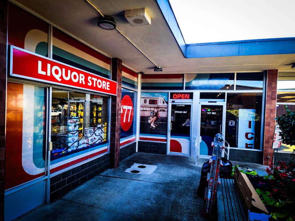 Liquor store exterior with bold signage, open sign, and welcoming entrance in Victoria.