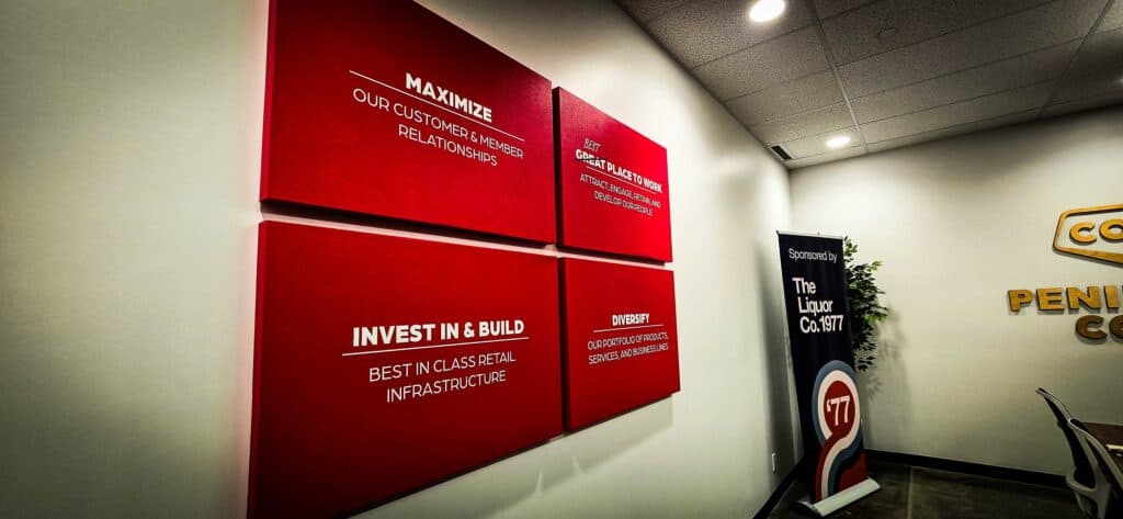 Modern red and white custom business signs displayed indoors in Victoria.