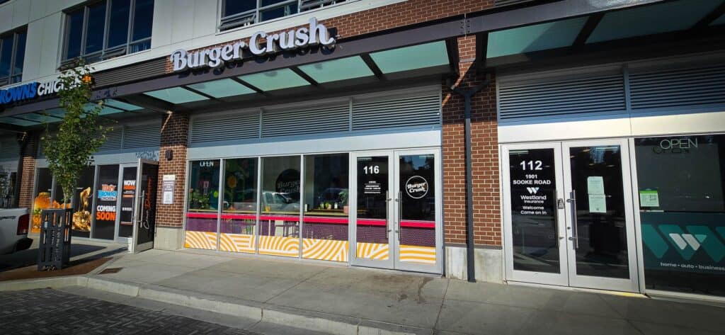 Burger Crush restaurant storefront with signage and glass windows in Victoria.