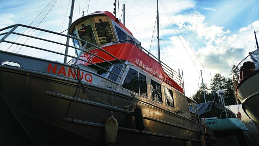 Custom boat signage on a yacht docked at Victoria marina.