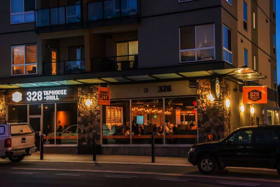 Exterior sign of Taphouse & Grill restaurant at night in Victoria.