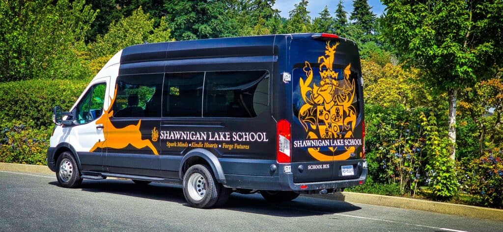 Custom vehicle wrap for Shawnigan Lake School with school crest and branding.