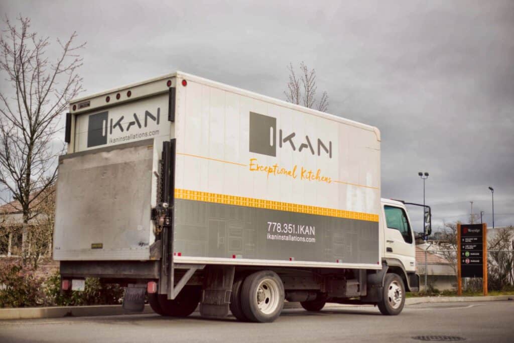 Custom sign truck for Kikan with branding and contact info.