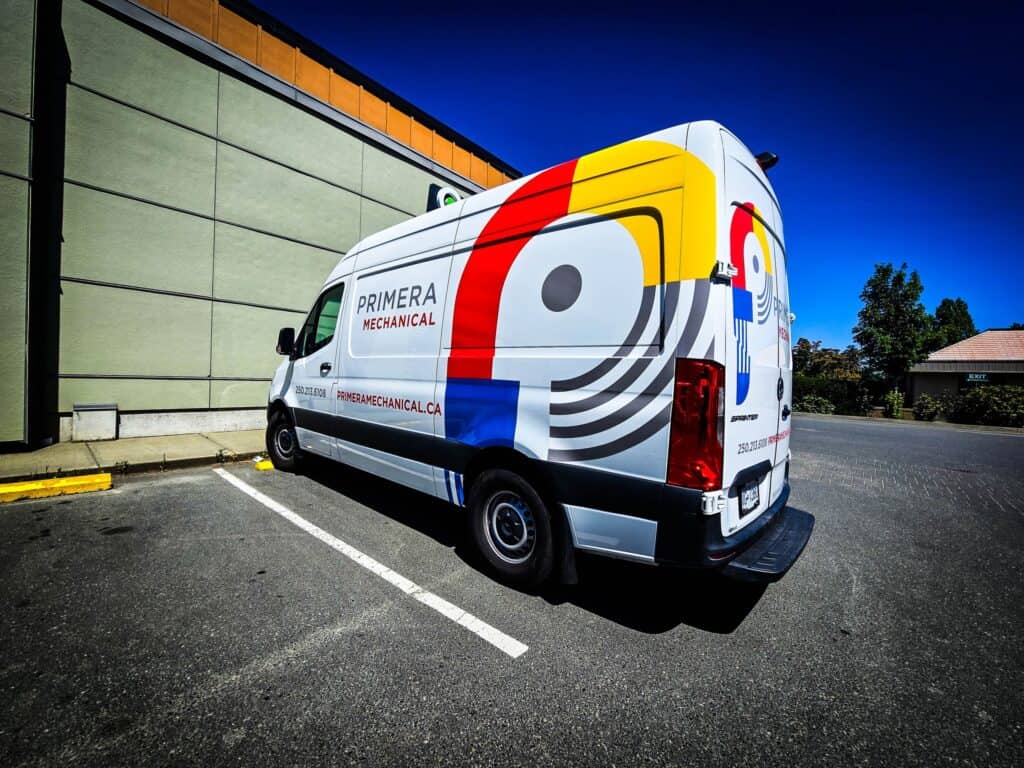 Custom vehicle wrap for Prime Mechanical on a white van in a parking lot.