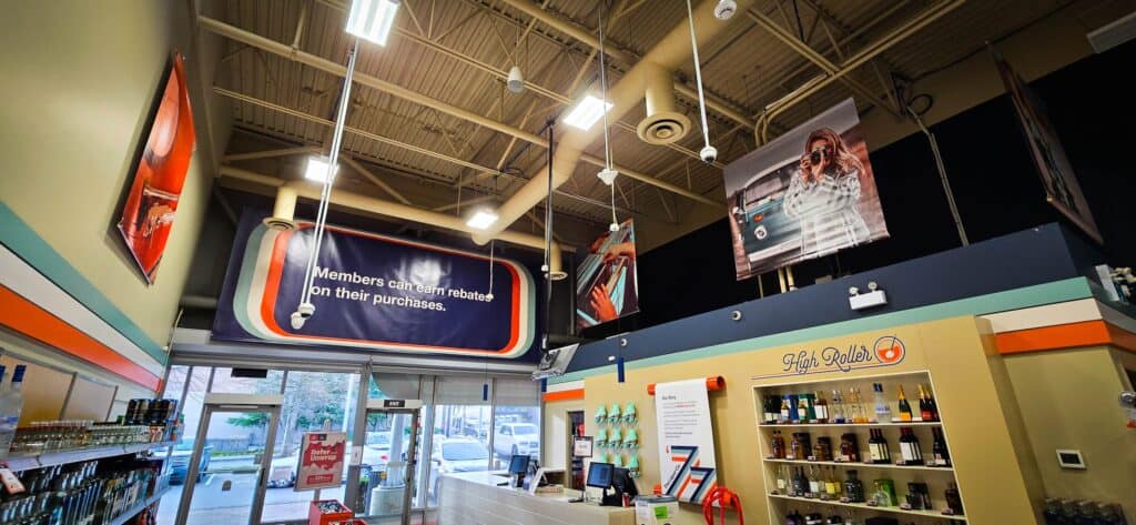 Interior view of a retail store showcasing custom signs and vehicle wraps in Victoria.