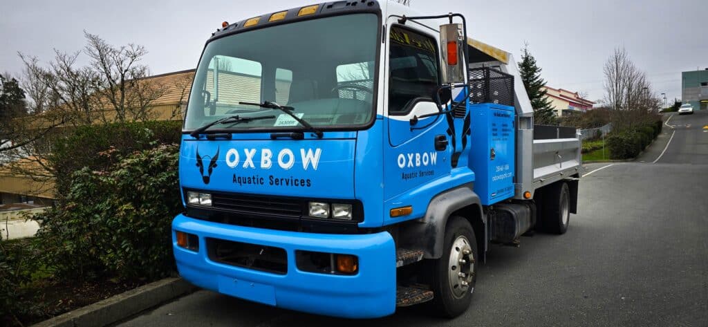 Custom vehicle wrap for Oxbow Aquatic Services on a blue truck.