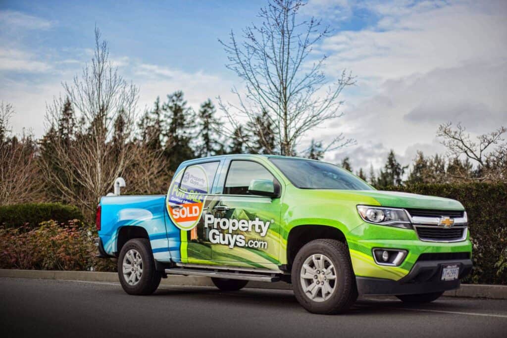 Custom vehicle wrap for Property Guys promoting real estate services.