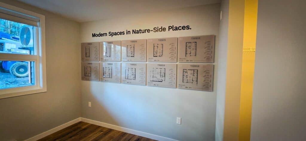 Modern interior space with wall-mounted architectural plans and a window.