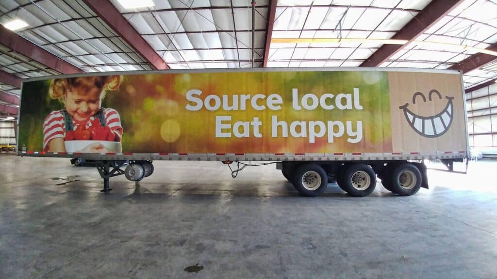 Large vehicle wrap promoting local food and happiness in Victoria.