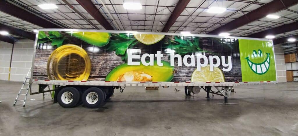 Large vibrant sign banner with "Eat Happy" message and smiley face graphic.