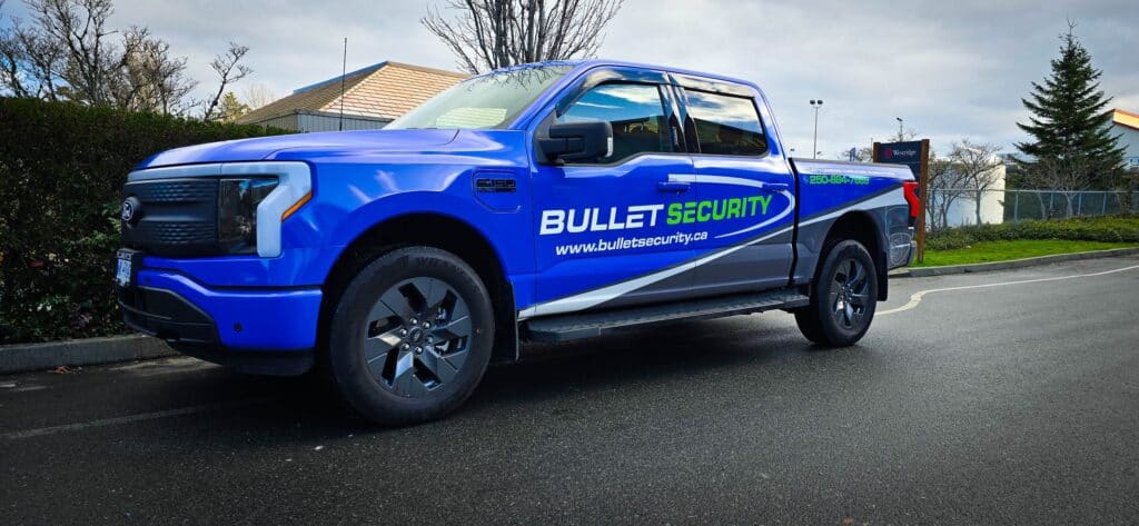 Custom Bullet Security vehicle wrap in blue with logo and website.