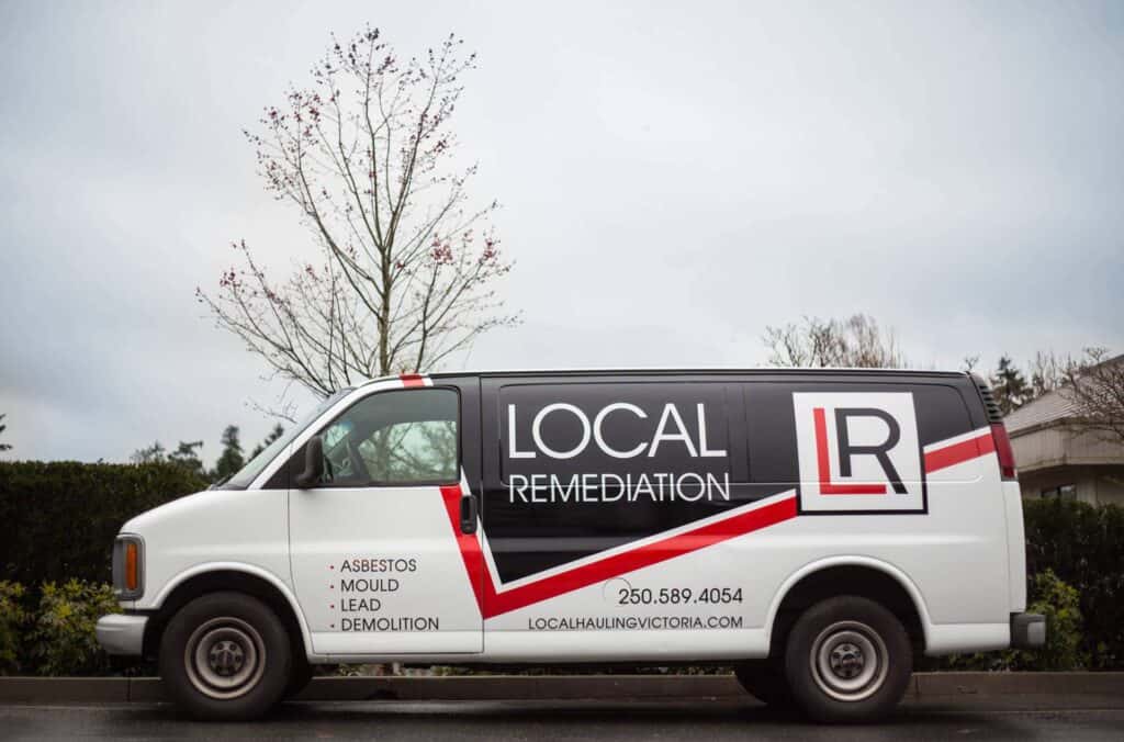 Local Remediation vehicle with custom signage for asbestos, mold, lead, and demolition services.