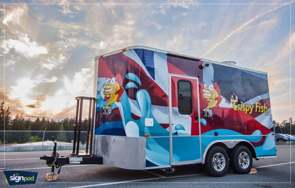 Vehicle wrap featuring Crispy Fish cartoon characters and vibrant colors.