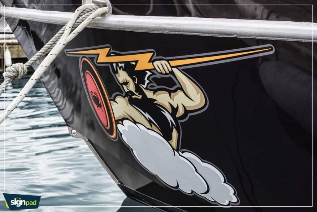 Boat graphic with a warrior holding a spear and shield.